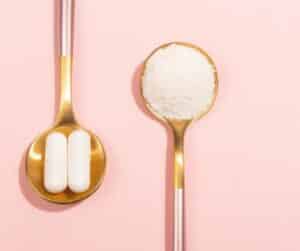 pcos and inositol two spoons with white powder and two white capsules