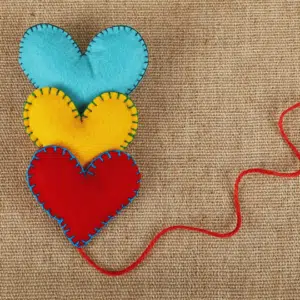 3 felt hearts, arranged in a line with a piece of string - heart connection