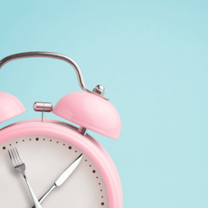 Image of clock with knife and fork for hands to show that you should slow down your eating with PCOS