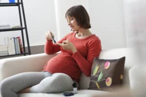 pregnant woman testing blood sugars - gestational diabetes