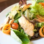 grilled-salmon-ceasar-salad-on-white-plate