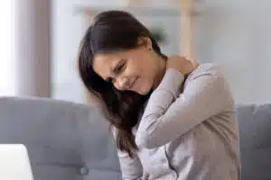 woman rubbing her sore neck