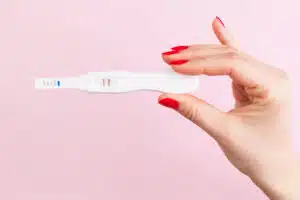 woman holding a positive pregnancy test