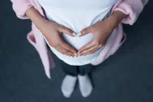 Pregnant woman holding belly