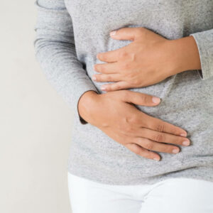 Women holding stomach - bloating