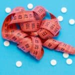 Inositol vs Metformin tape measure and white tablets